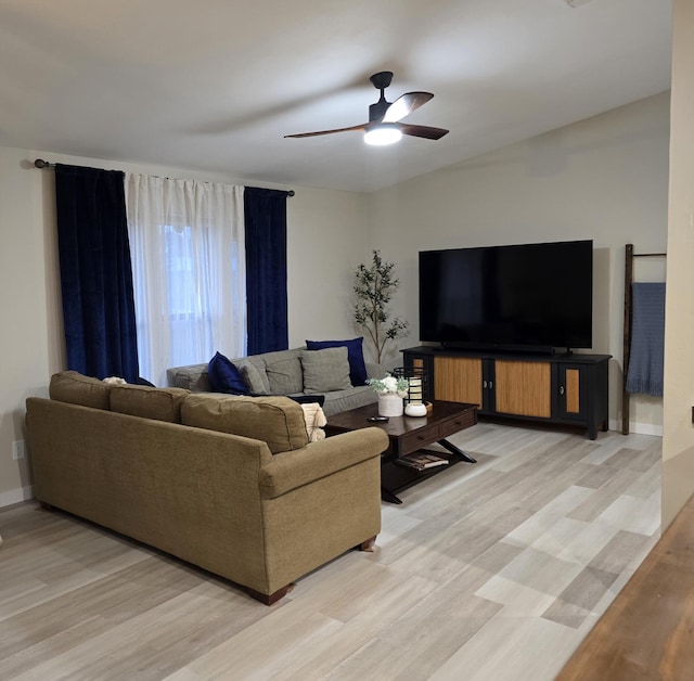 living room with ceiling fan and light wood-type flooring