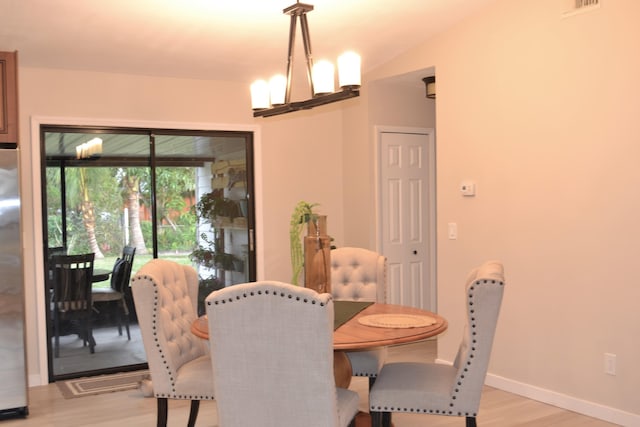 dining room featuring an inviting chandelier and light hardwood / wood-style flooring