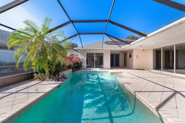 view of swimming pool featuring a lanai, ceiling fan, and a patio