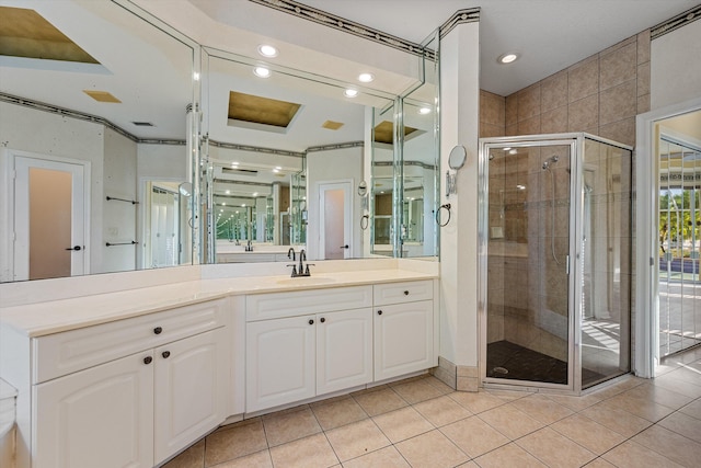 bathroom featuring tile patterned floors, vanity, and a shower with shower door