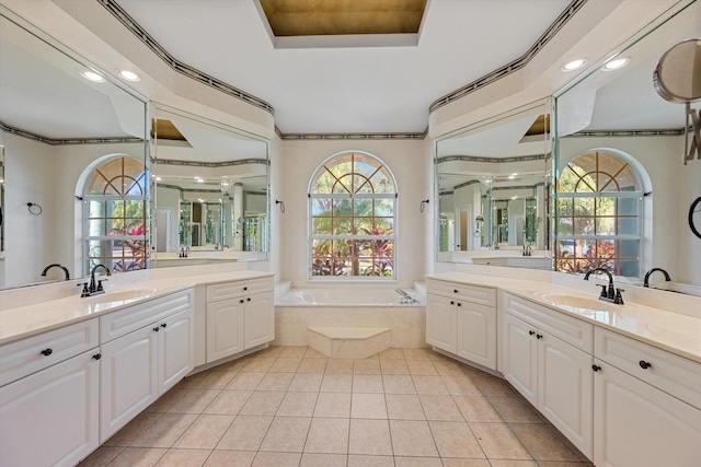 bathroom featuring tile patterned flooring, vanity, a relaxing tiled tub, and ornamental molding