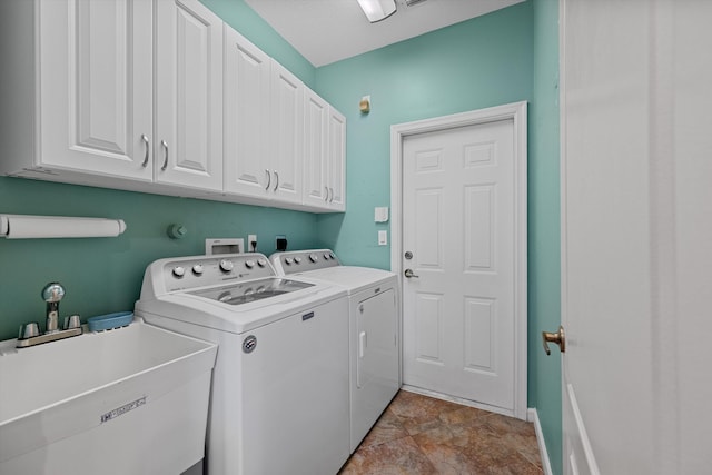 laundry area with cabinets, separate washer and dryer, and sink