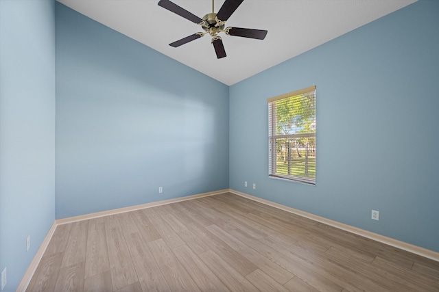 unfurnished room with ceiling fan, lofted ceiling, and light wood-type flooring