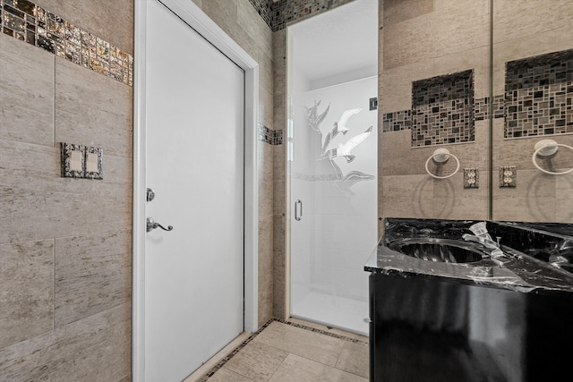 bathroom with vanity and a shower with shower door