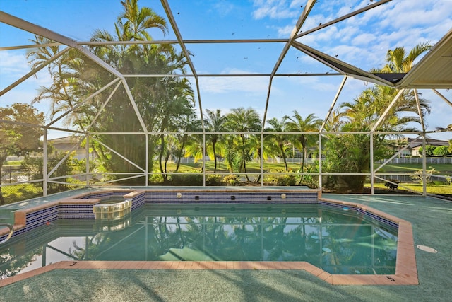 view of pool featuring a lanai and an in ground hot tub