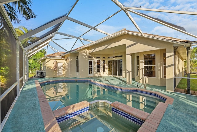 view of pool with a lanai, an in ground hot tub, ceiling fan, and a patio