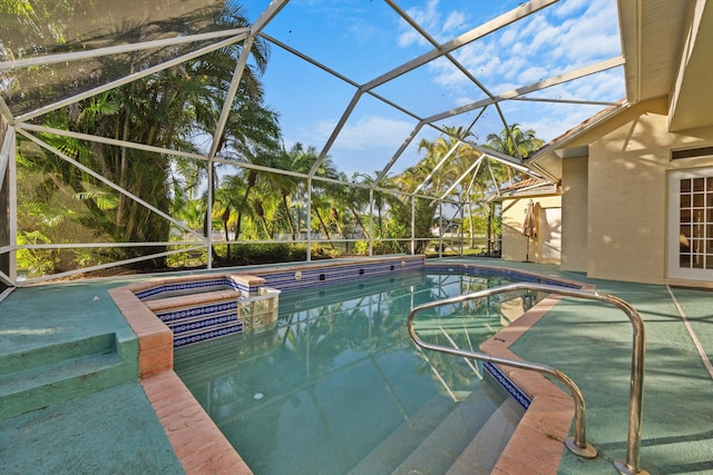 view of swimming pool featuring a lanai and a hot tub