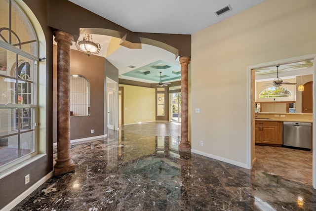 interior space featuring decorative columns and ceiling fan