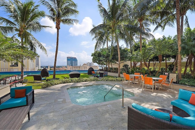 view of pool with a patio area and an in ground hot tub