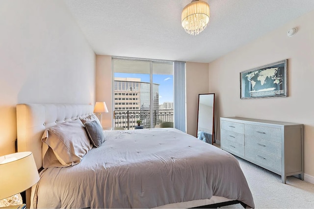 carpeted bedroom with a textured ceiling and access to outside