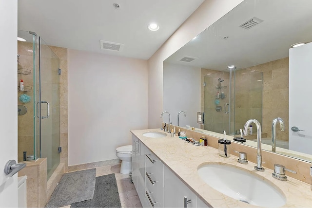 bathroom with vanity, toilet, and an enclosed shower