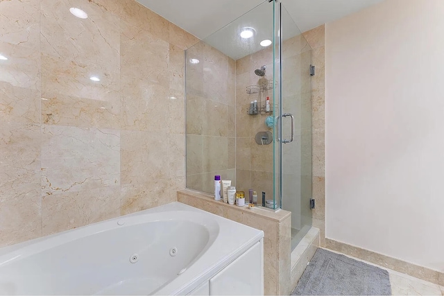 bathroom featuring separate shower and tub