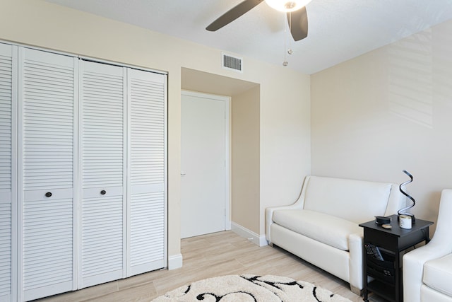 living area with ceiling fan and light wood-type flooring