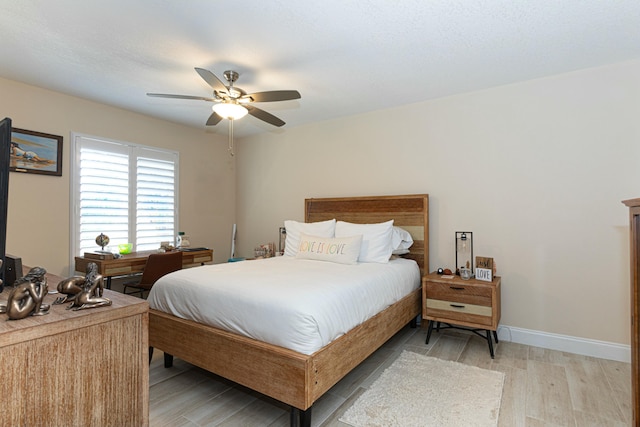 bedroom with ceiling fan and light hardwood / wood-style floors