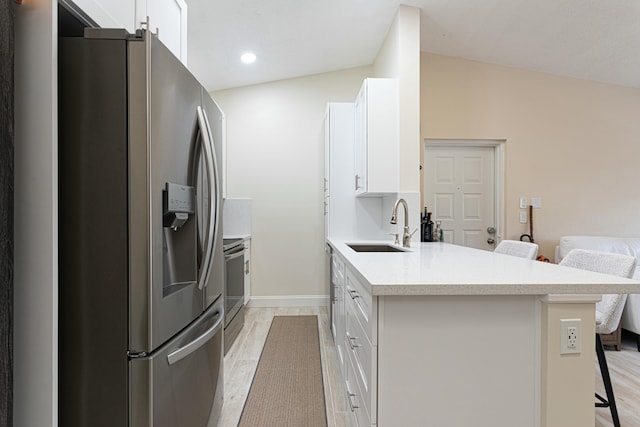 kitchen featuring a kitchen breakfast bar, kitchen peninsula, stainless steel fridge with ice dispenser, and white cabinetry