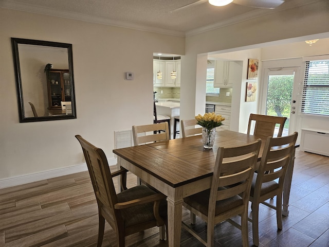 dining space featuring hardwood / wood-style floors, ceiling fan, and ornamental molding