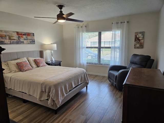 bedroom featuring a textured ceiling, ceiling fan, and dark hardwood / wood-style floors