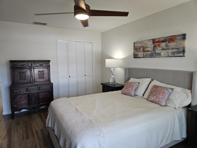 bedroom featuring dark hardwood / wood-style flooring, a closet, and ceiling fan