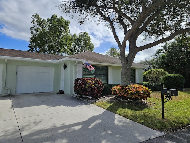 ranch-style house with a garage and a front lawn