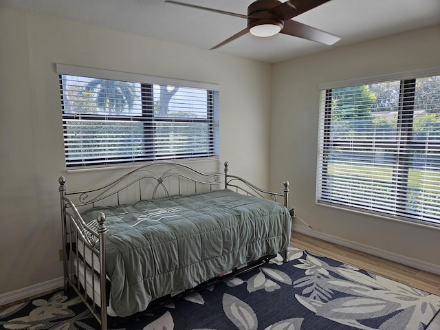 bedroom featuring hardwood / wood-style flooring and ceiling fan