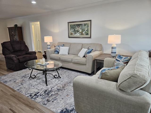 living room with hardwood / wood-style floors and ornamental molding