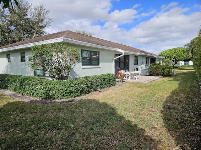 back of property featuring a yard and a patio