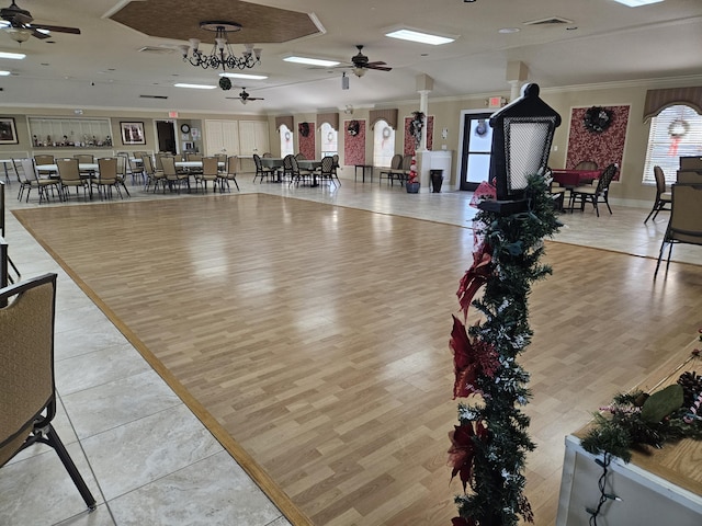 gym featuring ceiling fan, light hardwood / wood-style flooring, and ornamental molding