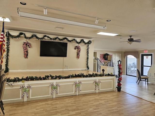 interior space with light hardwood / wood-style floors, ceiling fan, and crown molding