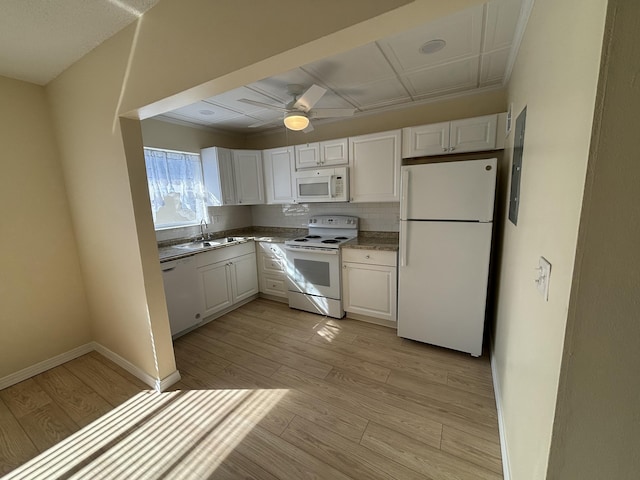 kitchen featuring sink, white cabinets, light hardwood / wood-style floors, and white appliances