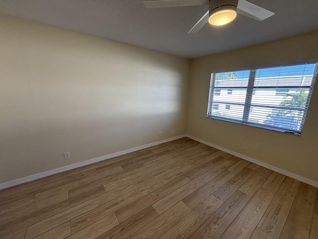 empty room with light hardwood / wood-style flooring and ceiling fan