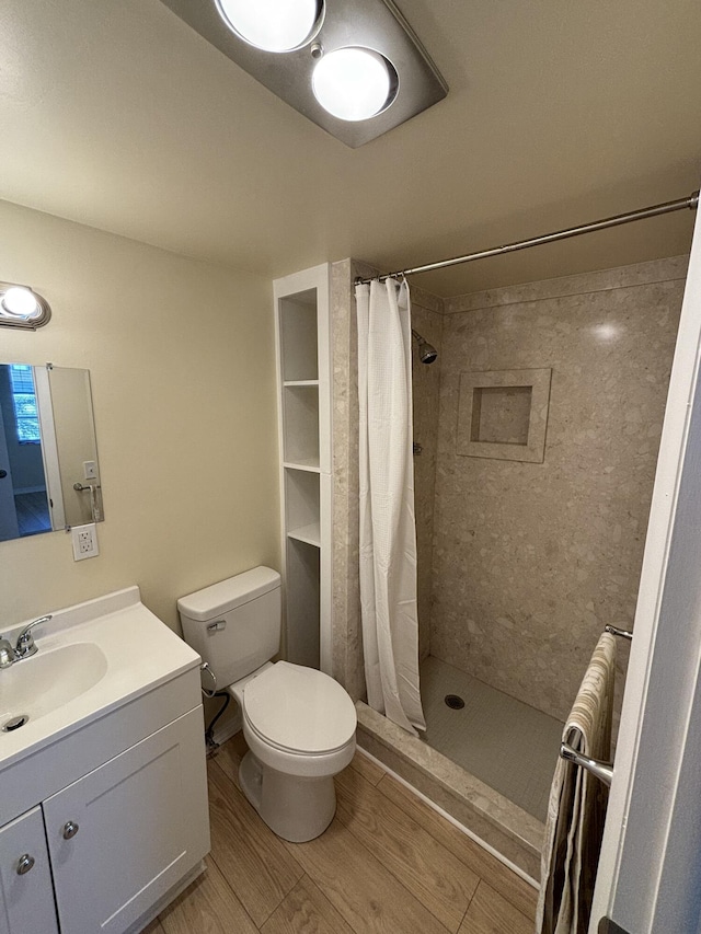 bathroom featuring vanity, curtained shower, toilet, and wood-type flooring