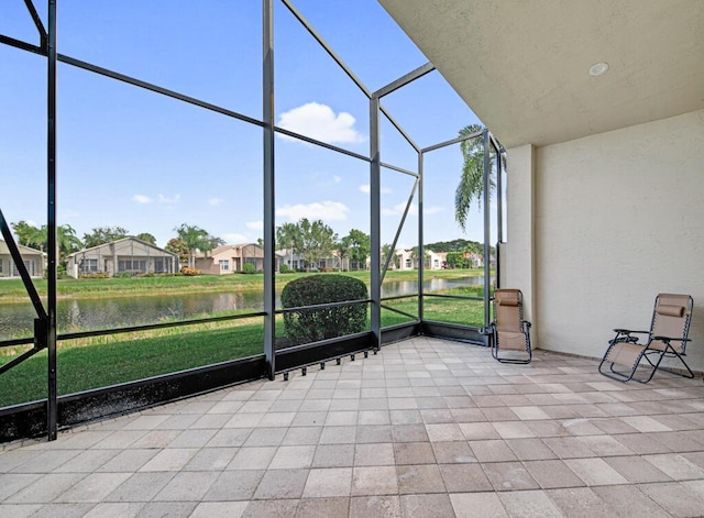 unfurnished sunroom with a water view