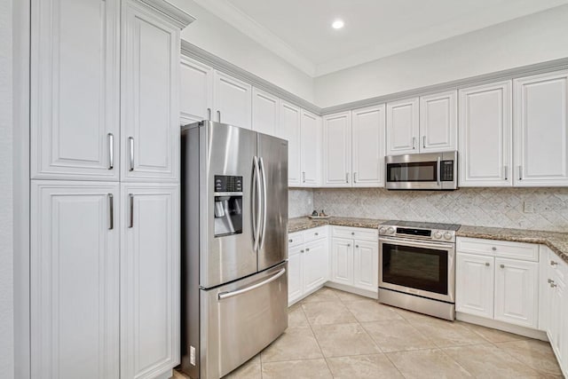 kitchen with light stone countertops, appliances with stainless steel finishes, white cabinetry, and crown molding