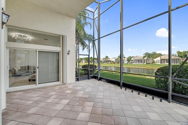 unfurnished sunroom featuring a water view