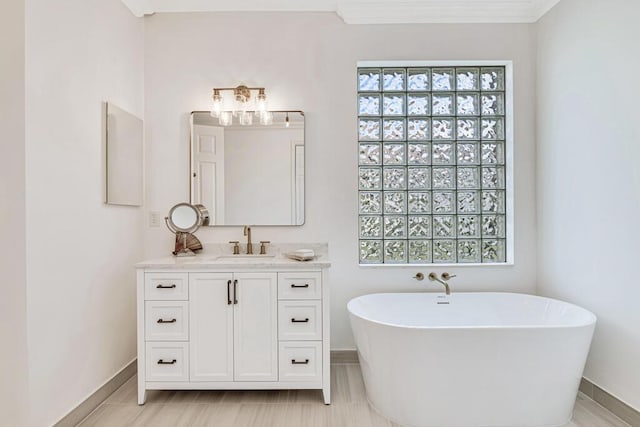 bathroom with a bath, vanity, and ornamental molding