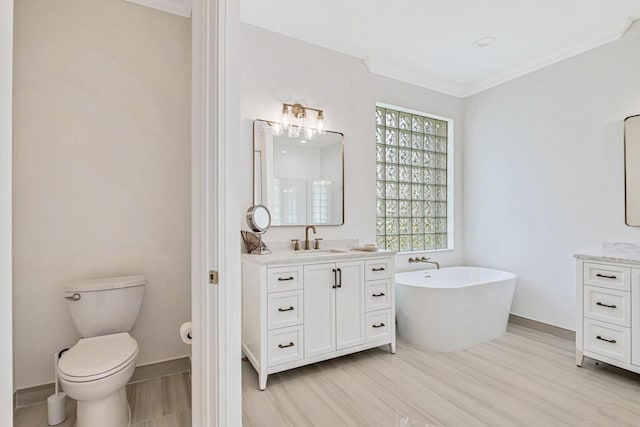 bathroom featuring crown molding, hardwood / wood-style floors, vanity, and toilet