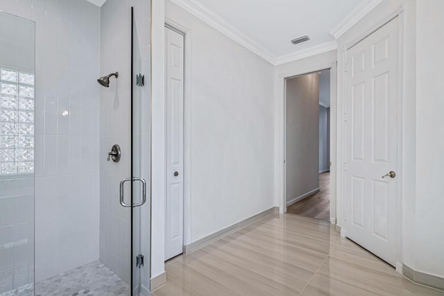 bathroom featuring hardwood / wood-style flooring, an enclosed shower, and ornamental molding