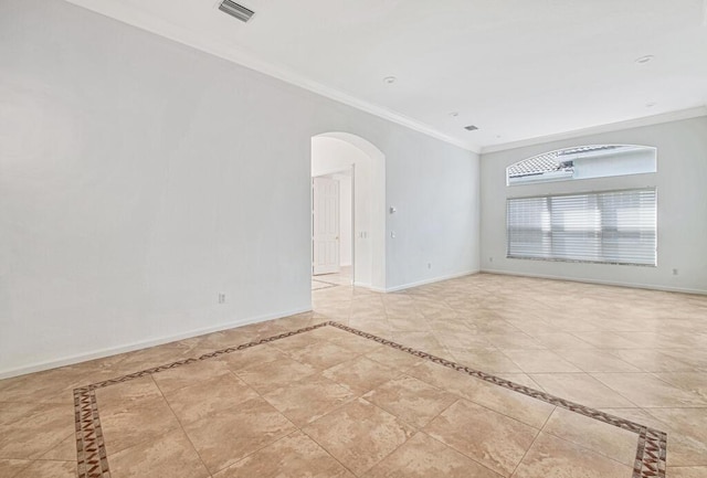 tiled empty room featuring crown molding