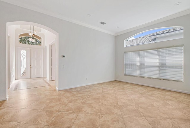 tiled foyer entrance featuring a wealth of natural light and crown molding