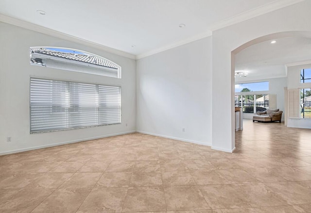 spare room with light tile patterned flooring and ornamental molding