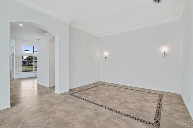 tiled spare room with crown molding