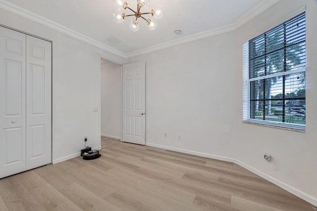 unfurnished bedroom with crown molding, light hardwood / wood-style floors, and an inviting chandelier