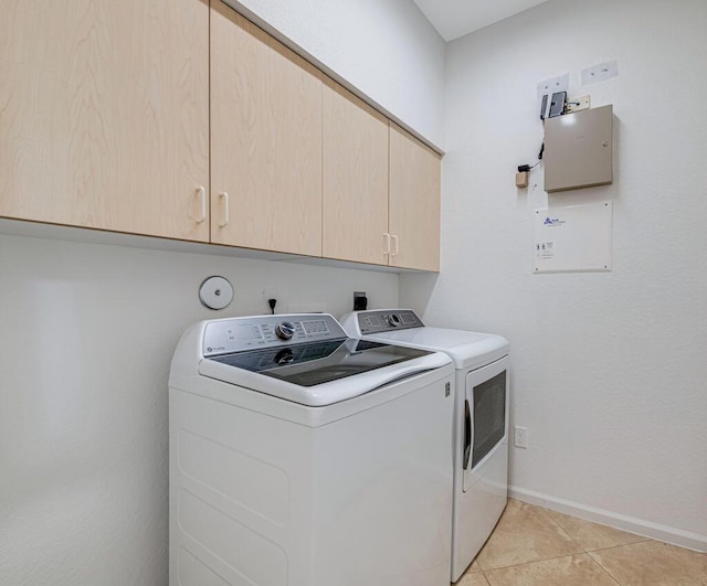 washroom featuring light tile patterned flooring, cabinets, and independent washer and dryer