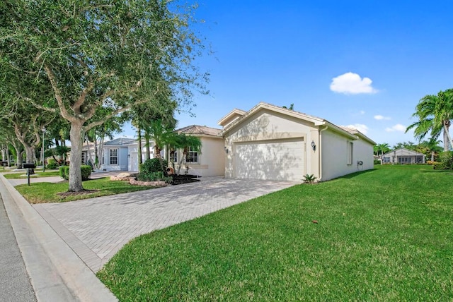 single story home featuring a front lawn and a garage