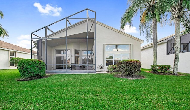 rear view of property featuring a yard and a lanai