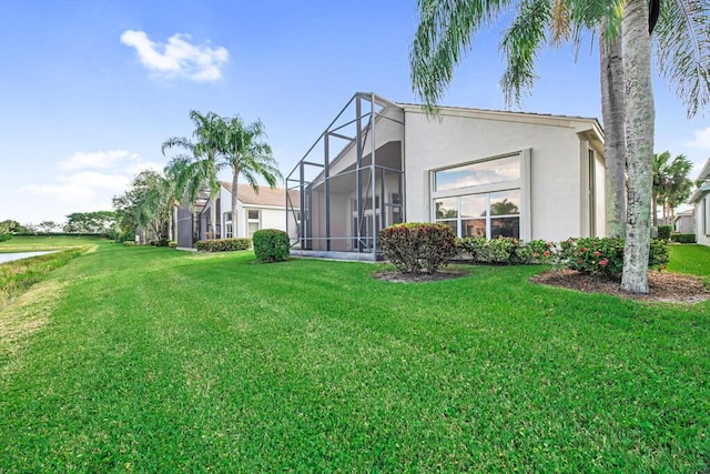 back of property with a lawn and glass enclosure