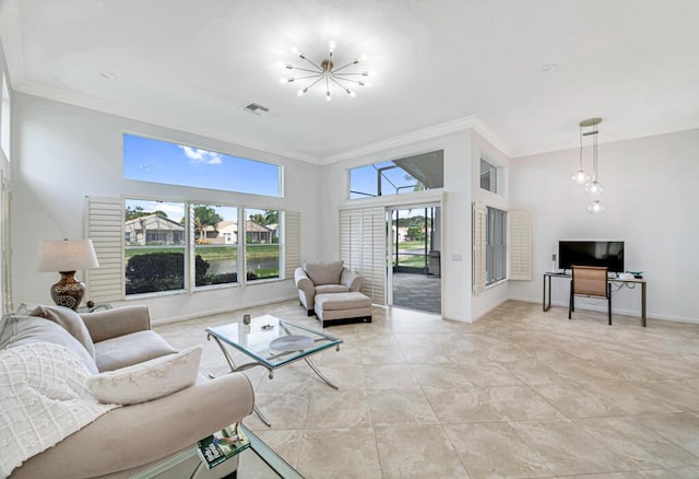 living room with plenty of natural light, ornamental molding, a towering ceiling, and a chandelier