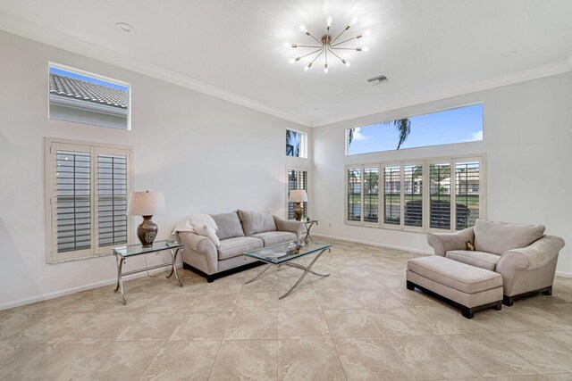 tiled living room with a high ceiling, an inviting chandelier, and ornamental molding