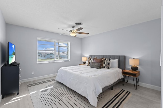 bedroom with ceiling fan and light hardwood / wood-style floors