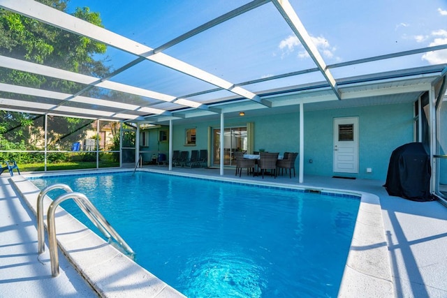 view of pool with a patio area and a lanai